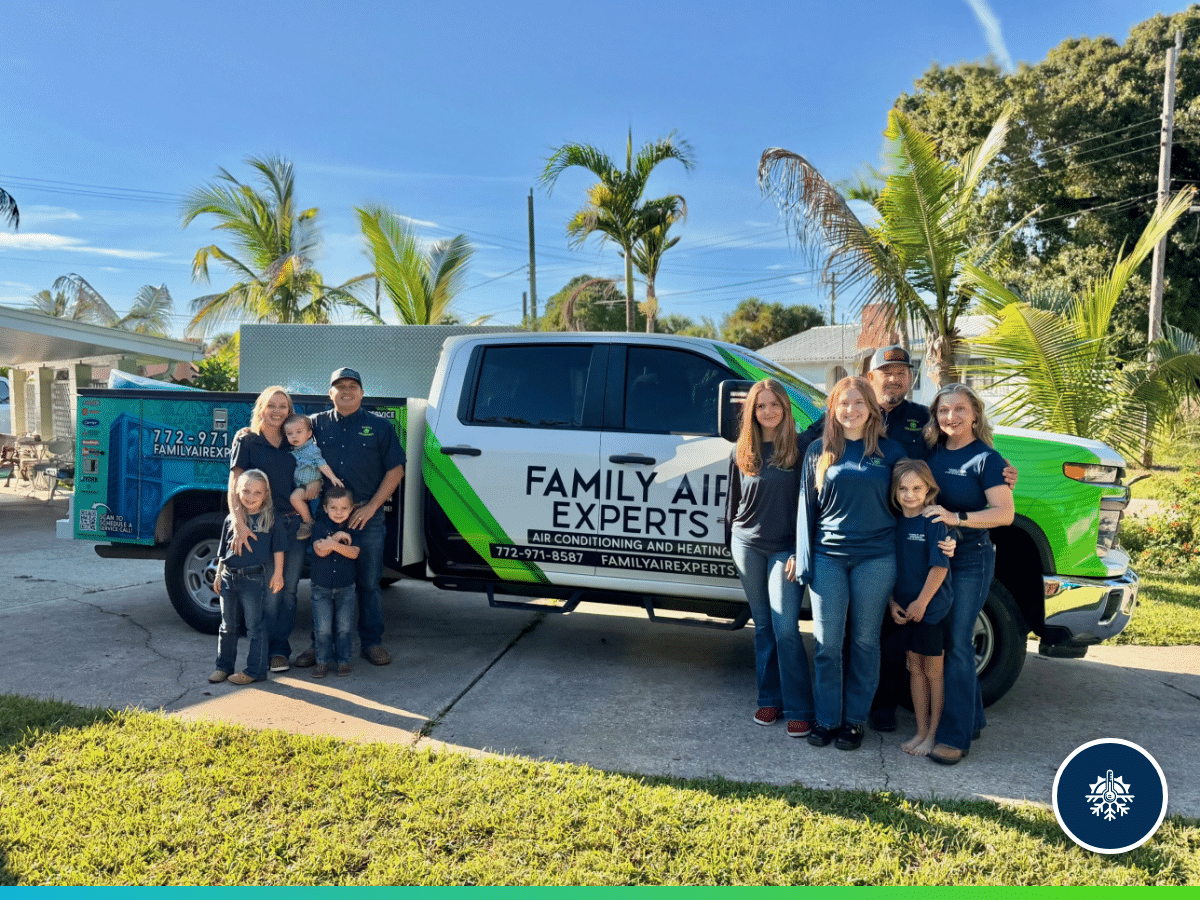 Our Community 86 Family Air Experts owners Nathan and Dalton with their families beside a Family Air Experts service truck in Fort Pierce, Florida